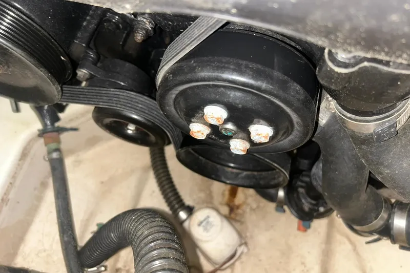 Slide: The Image of Engine components of a 2017 Bayliner VR6 Bowrider I/O with visible belts and hoses. - 51