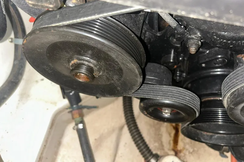 Slide: The Image of Engine pulleys and belts of a 2017 Bayliner VR6 Bowrider I/O boat. - 52