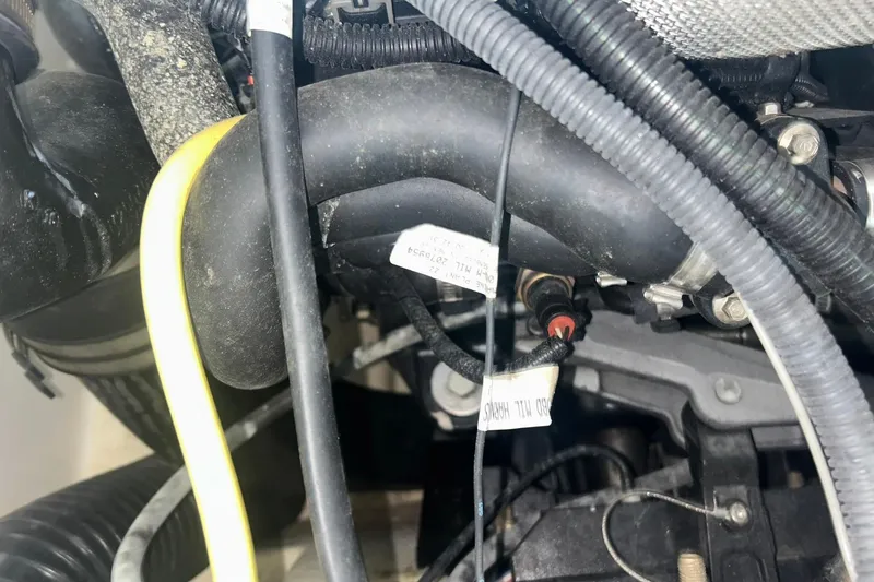 Slide: The Image of Engine components of a 2017 Bayliner VR6 Bowrider I/O boat, featuring hoses and wiring. - 55