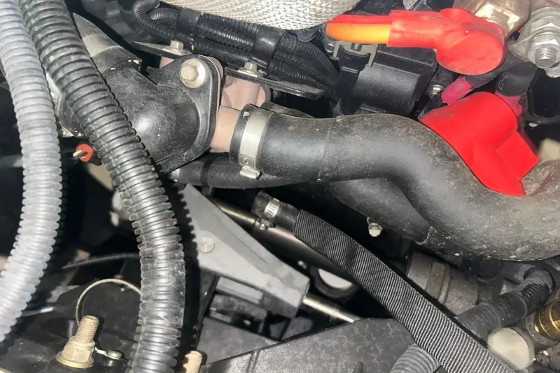 Slide: The Image of Engine components of a 2017 Bayliner VR6 Bowrider I/O, featuring hoses and wiring. - 56