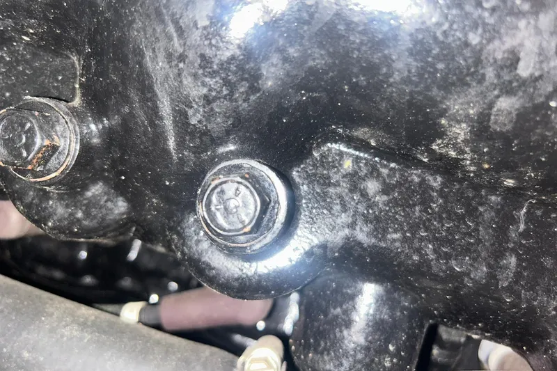 Slide: The Image of Close-up of a 2017 Bayliner VR6 Bowrider I/O engine component with bolts. - 60