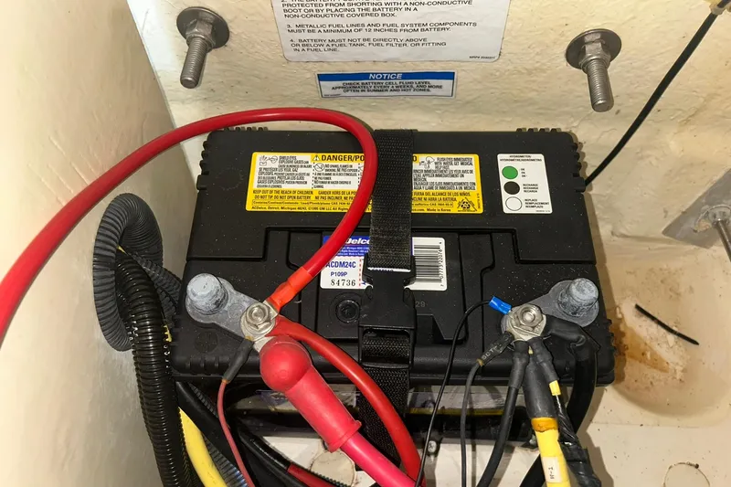 Slide: The Image of Battery compartment of a 2017 Bayliner VR6 Bowrider I/O with connected cables. - 63