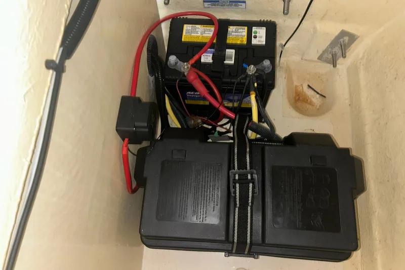 Slide: The Image of Battery compartment of 2017 Bayliner VR6 Bowrider I/O with wiring and secure casing. - 64