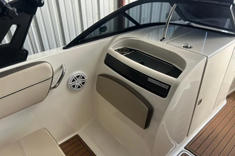 Slide: The Image of 2017 Bayliner VR6 Bowrider I/O interior with seating, speaker, and storage compartment. - 9