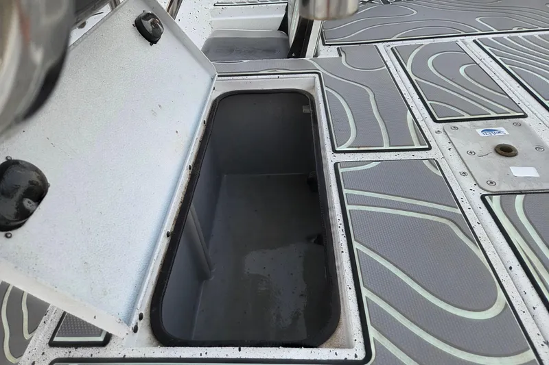 Slide: The Image of Open storage compartment on 2023 Xpress H22B Bay boat deck. - 10