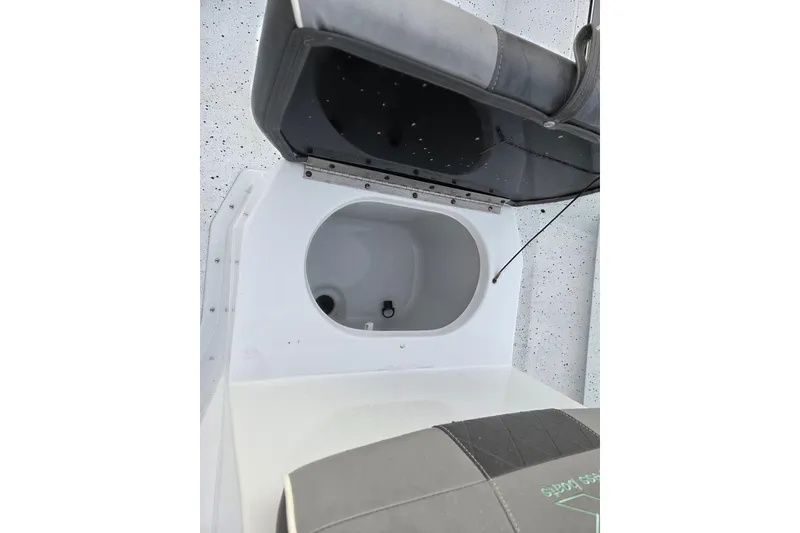 Slide: The Image of 2023 Xpress H22B Bay boat storage compartment with open lid. - 13