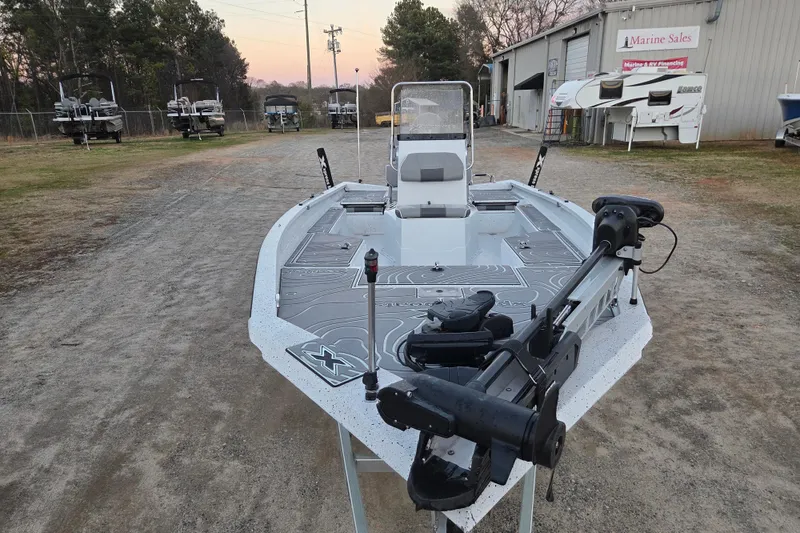 Slide: The Image of 2023 Xpress H22B Bay boat at a marine sales lot, featuring advanced equipment. - 2