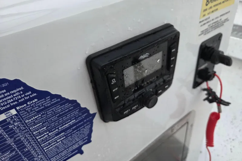 Slide: The Image of Control panel on 2023 Xpress H22B Bay boat, featuring water droplets and safety instructions. - 7