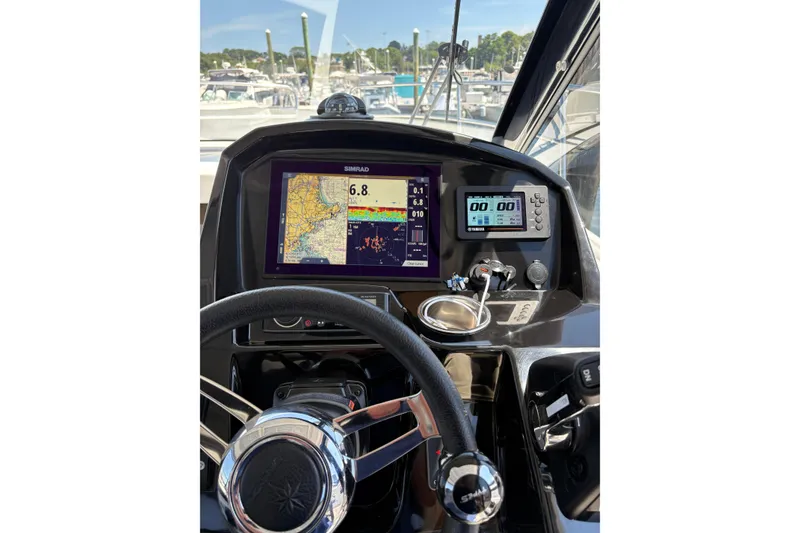 Slide: The Image of Cockpit view of 2020 Jeanneau NC 895 with navigation displays and steering wheel. - 11