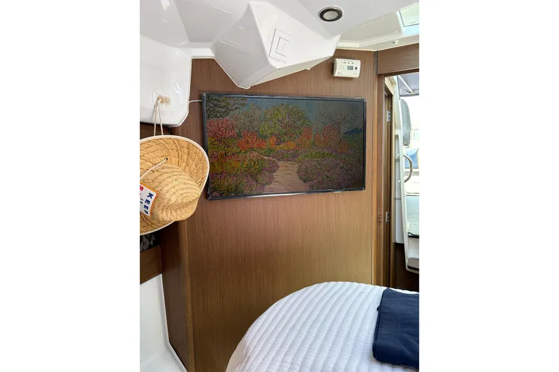 Slide: The Image of Interior of 2020 Jeanneau NC 895 with wall art and straw hat. - 15