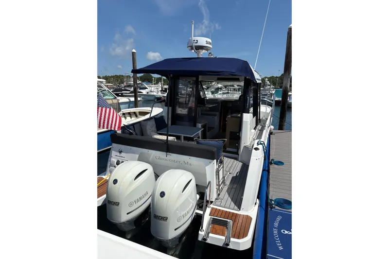 Slide: The Image of 2020 Jeanneau NC 895 boat docked, featuring twin Yamaha 200 engines. - 2