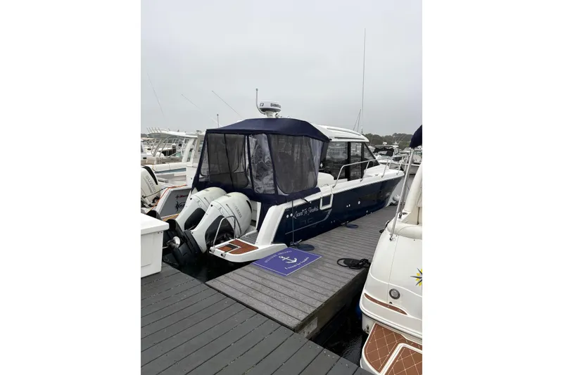 Slide: The Image of 2020 Jeanneau NC 895 boat docked at marina with twin outboard engines. - 5