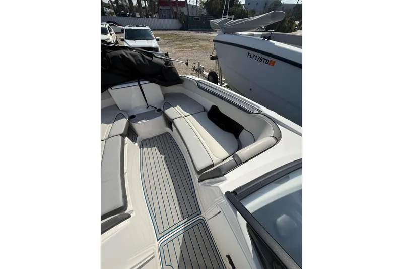 Slide: The Image of 2023 Yamaha Boats AR250 interior with cushioned seating and sleek design. - 10