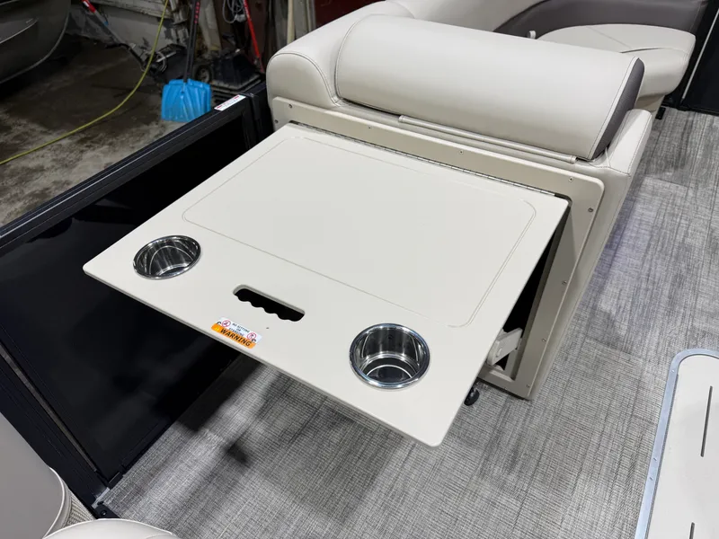 Slide: The Image of 2026 Bentley Pontoons Legacy Tritoon with fold-out table and cup holders. - 27