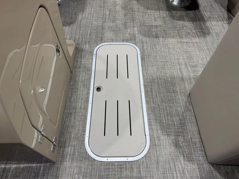 Slide: The Image of Interior of 2026 Bentley Pontoons Legacy with carpet flooring and storage compartment. - 31
