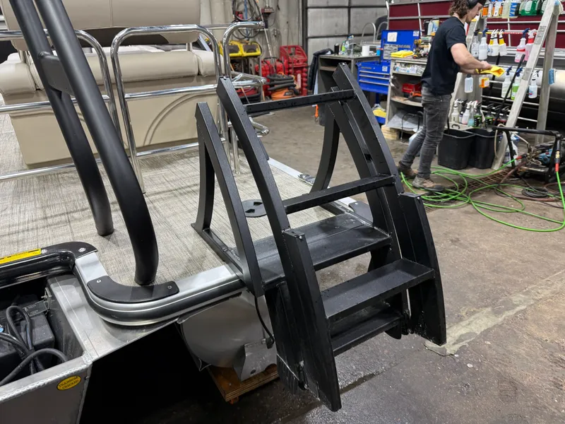 Slide: The Image of 2026 Bentley Pontoons Legacy Tritoon with black ladder in workshop. - 43