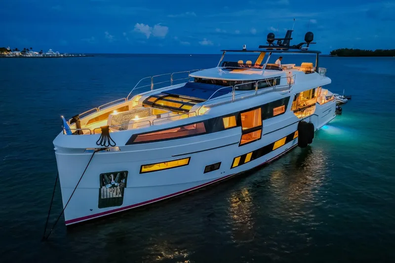 The Image of Luxurious 2021 Sirena 88 yacht illuminated at night on calm waters. - 0
