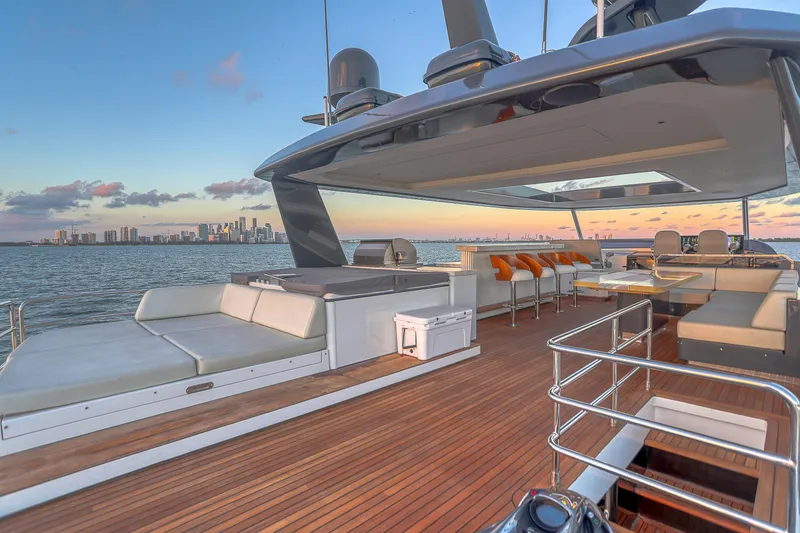 Slide: The Image of Luxurious 2021 Sirena 88 yacht deck with city skyline at sunset. - 11