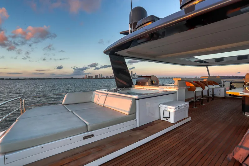 Slide: The Image of Luxurious 2021 Sirena 88 yacht deck with seating, overlooking serene ocean sunset. - 12