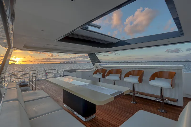 Slide: The Image of Luxurious 2021 Sirena 88 yacht interior with sunset view, featuring elegant seating and modern design. - 14