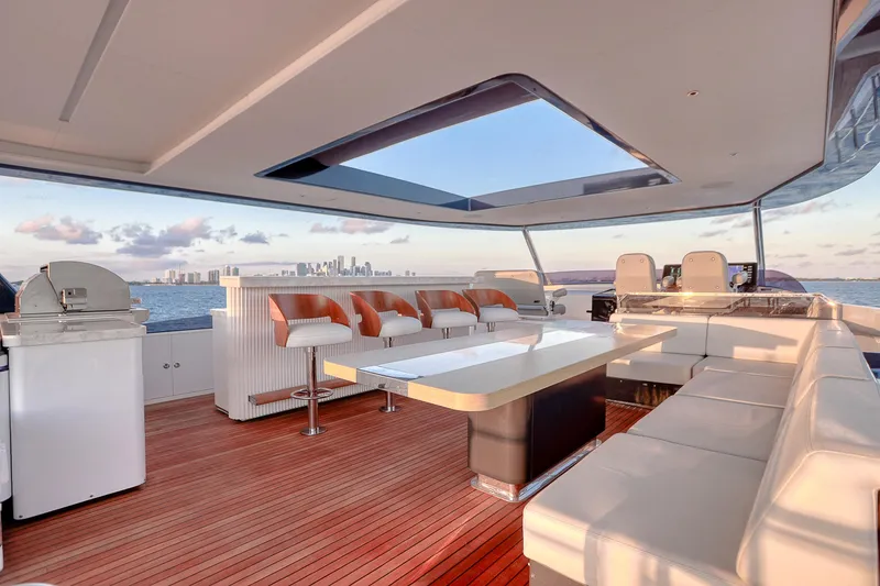 Slide: The Image of Luxurious 2021 Sirena 88 yacht deck with seating, table, and ocean view. - 16