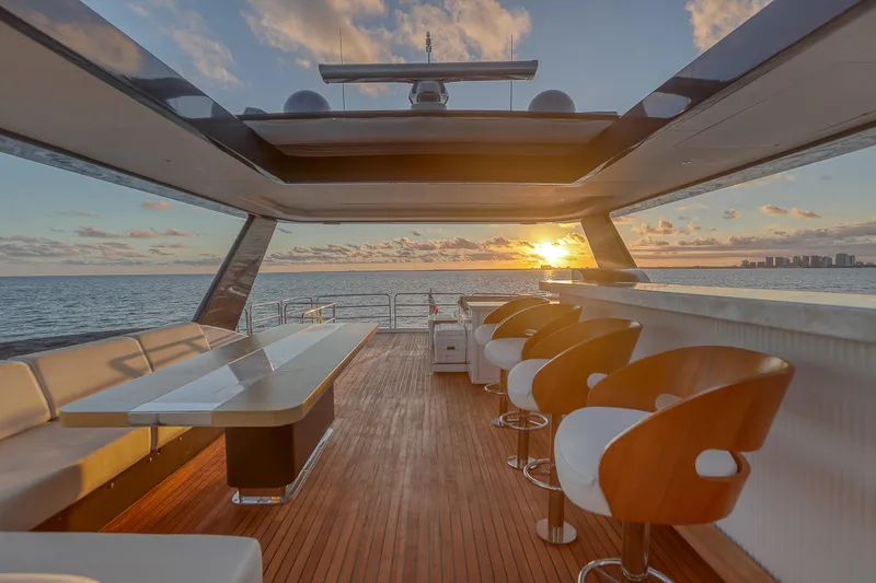 Slide: The Image of Luxurious 2021 Sirena 88 yacht deck at sunset, featuring elegant seating and ocean views. - 18