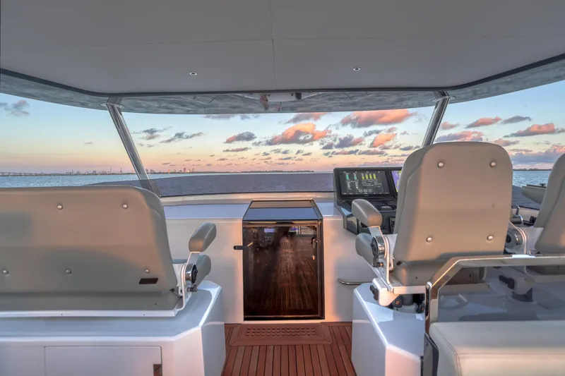 Slide: The Image of Helm of 2021 Sirena 88 yacht with ocean view at sunset. - 20