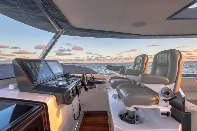 Slide: The Image of Luxurious 2021 Sirena 88 yacht helm with modern controls and ocean view at sunset. - 22
