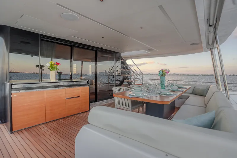 Slide: The Image of Luxurious Sirena 88 yacht deck with elegant dining setup, ocean view, and modern design, 2021 model. - 24