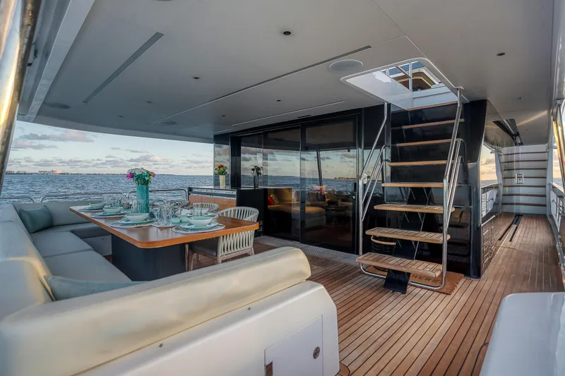 Slide: The Image of Luxurious 2021 Sirena 88 yacht deck with elegant dining setup and ocean view. - 25