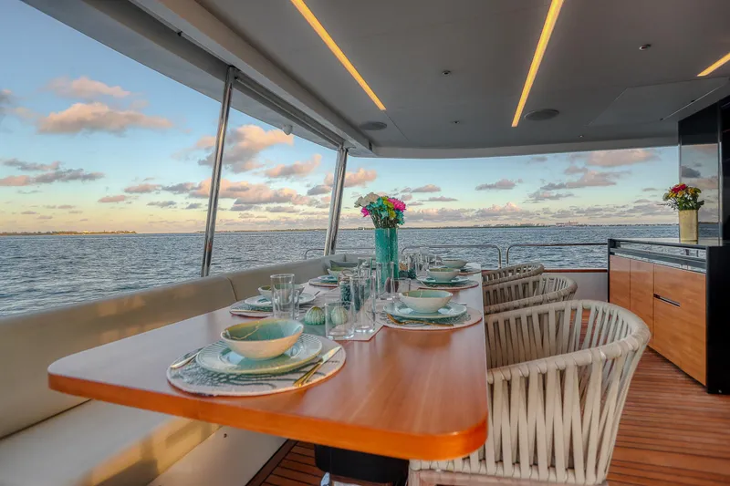 Slide: The Image of Luxurious dining area on 2021 Sirena 88 yacht with ocean view and elegant table setting. - 26