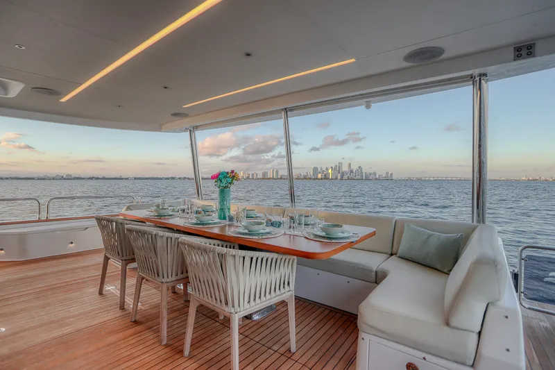 Slide: The Image of Luxurious dining area on 2021 Sirena 88 yacht with city skyline view. - 27