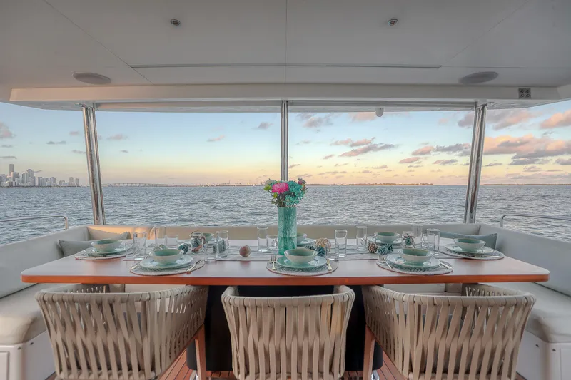 Slide: The Image of Elegant dining setup on Sirena 88 yacht, 2021, with ocean view at sunset. - 28