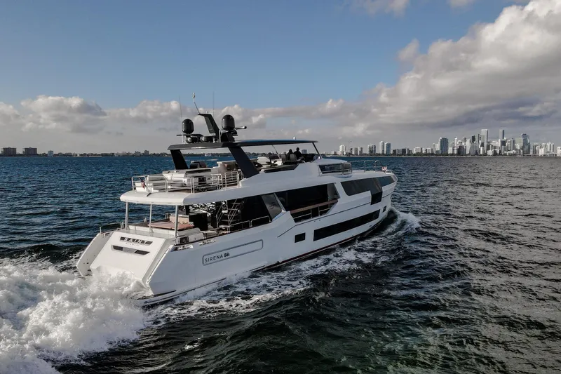 Slide: The Image of Luxury Sirena 88 yacht cruising near city skyline, 2021 model. - 3