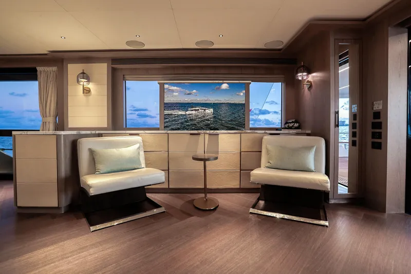 Slide: The Image of Luxurious interior of 2021 Sirena 88 yacht with ocean view through large window. - 32