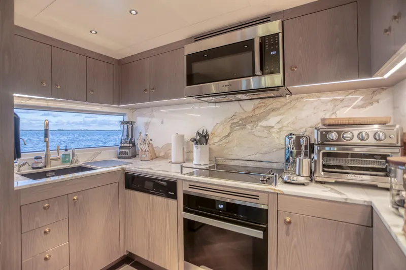 Slide: The Image of Modern kitchen interior on 2021 Sirena 88 yacht with ocean view and sleek appliances. - 38