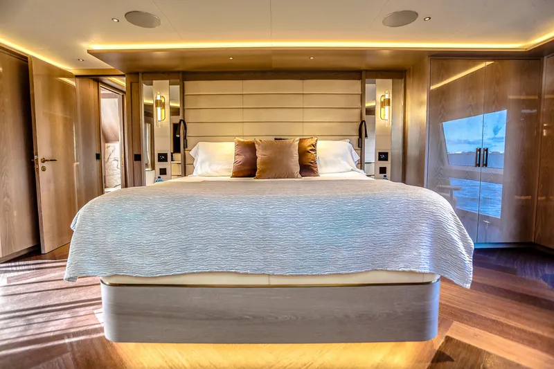 Slide: The Image of Luxurious bedroom interior on 2021 Sirena 88 yacht, featuring elegant design and ambient lighting. - 43