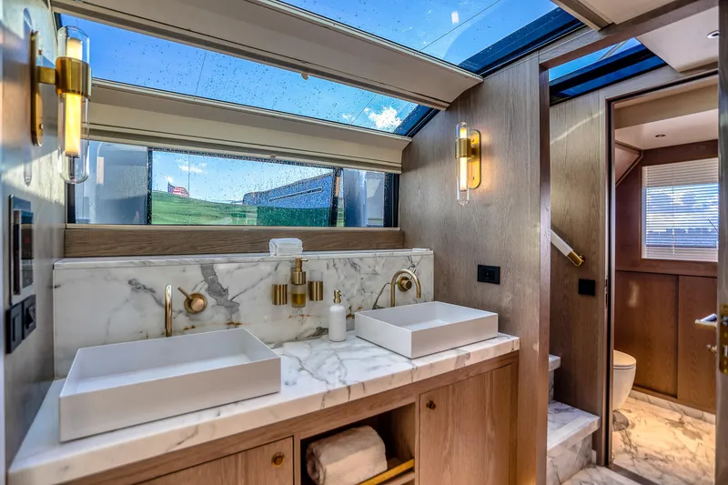 Slide: The Image of Luxurious Sirena 88 yacht bathroom with marble sinks and skylight, 2021 model. - 48