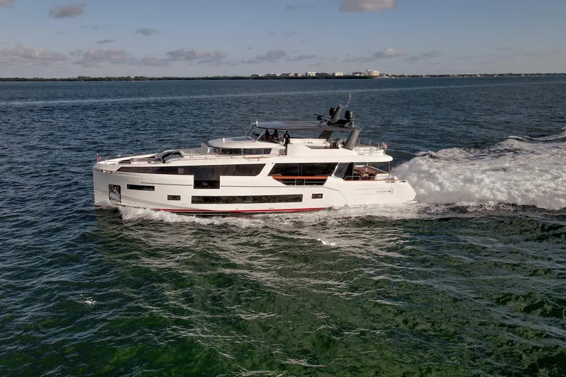 Slide: The Image of Luxurious 2021 Sirena 88 yacht cruising on open water under a clear sky. - 5