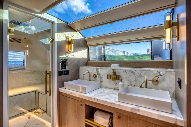 Slide: The Image of Luxurious bathroom interior of 2021 Sirena 88 yacht with marble countertops and skylight. - 51