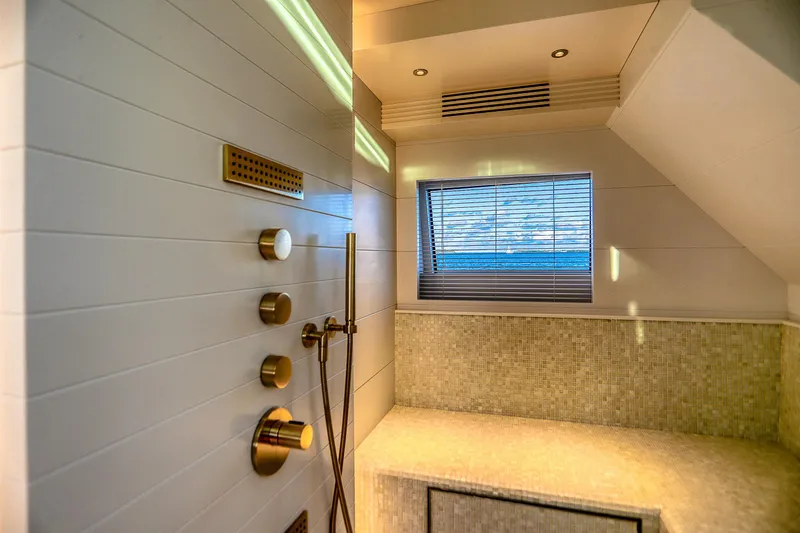 Slide: The Image of Luxurious bathroom interior on 2021 Sirena 88 yacht, featuring modern shower controls and window view. - 53