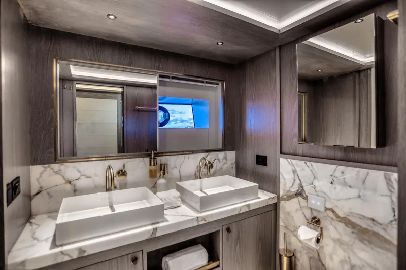 Slide: The Image of Luxurious bathroom in 2021 Sirena 88 yacht with dual sinks and marble accents. - 58