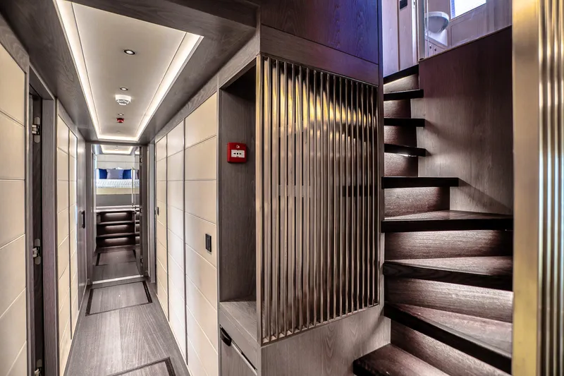 Slide: The Image of Luxurious interior of 2021 Sirena 88 yacht featuring modern hallway and elegant staircase. - 59