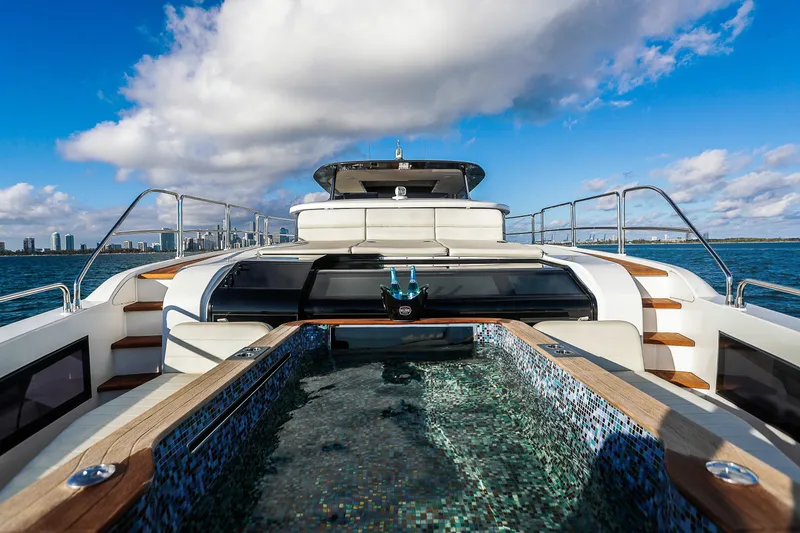 Slide: The Image of Luxurious 2021 Sirena 88 yacht with jacuzzi, city skyline in background. - 7