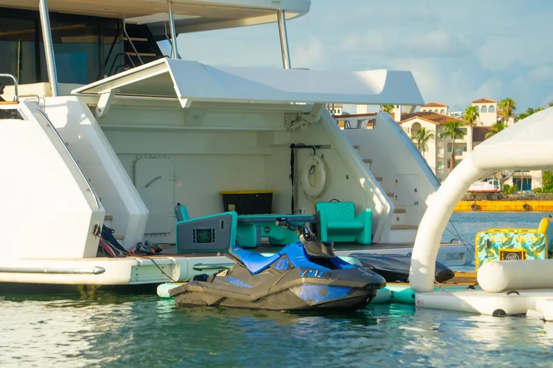 Slide: The Image of Luxury Sirena 88 yacht with jet ski docked, 2021 model, in a sunny marina setting. - 72