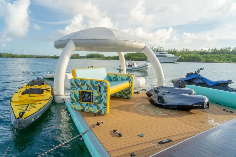 Slide: The Image of Floating deck with kayaks, jet skis, and inflatable lounge on serene water. Sirena 88, 2021. - 74