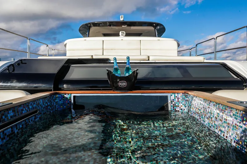 Slide: The Image of Luxury Sirena 88 yacht with pool and champagne, 2021 model, under blue sky. - 8