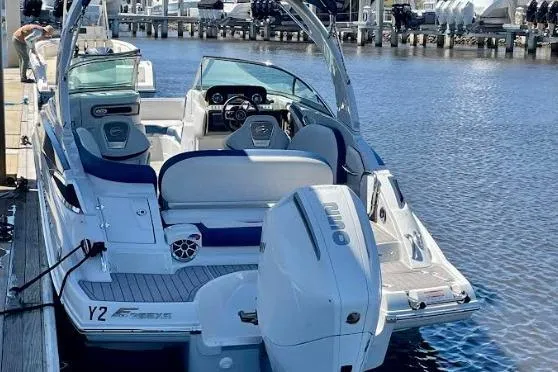 Slide: The Image of 2021 Crownline Eclipse E255 XS boat docked, featuring sleek design and spacious seating. - 3