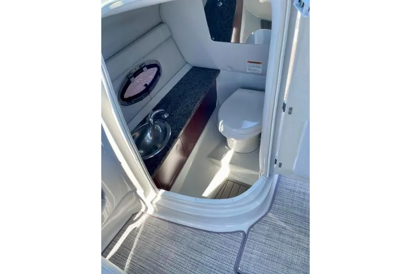 Slide: The Image of 2021 Crownline Eclipse E255 XS boat interior with toilet and sink. - 4