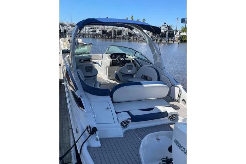 Slide: The Image of 2021 Crownline Eclipse E255 XS boat with spacious seating and sleek design at a dock. - 7